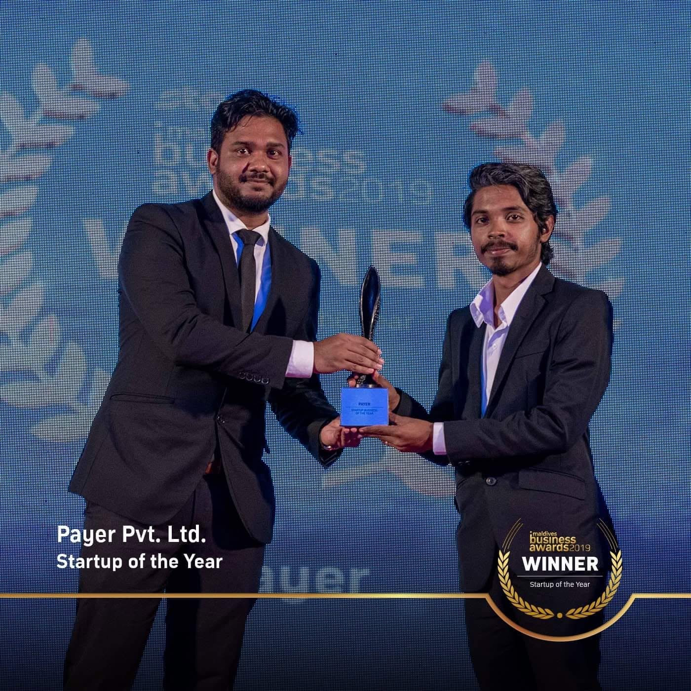 Two members of the Payer team on stage accepting the Startup of the Year trophy at the Maldives Business Awards 2019.